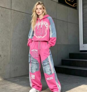 Bluza z kapturem i spodnie cargo z denimowymi wstawkami, patchwork - modelka w różowym zestawie na miejskiej ulicy