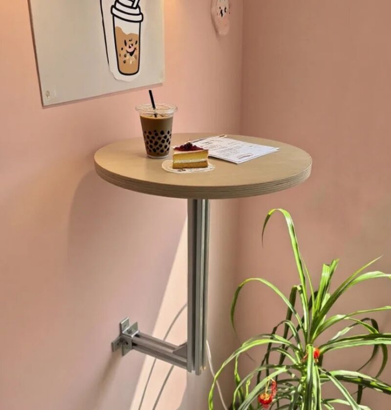 Stolik ścienny okrągły na aluminiowym wsporniku, drewniany blat - jasny przedpokój lub balkon w stylu skandynawskim, stolik przy ścianie obok rośliny